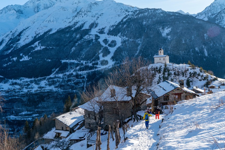 Skiers return to a French village in the Alps.